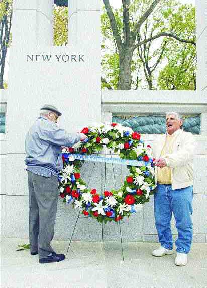 World War II veterans Joseph Aiello, left, and Raymond DeLuke, both of Frankfort, adjust the Herkimer County WWII Veterans wreath Friday in front of the New York pillar at the National World War II Memorial in Washington, D.C. Aiello served in the Army and DeLuke in the Navy. BILL CLARK / Gannett News Service